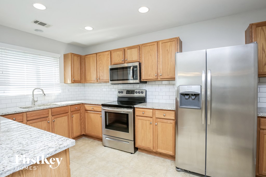 a kitchen with wooden cabinets and stainless steel appliances