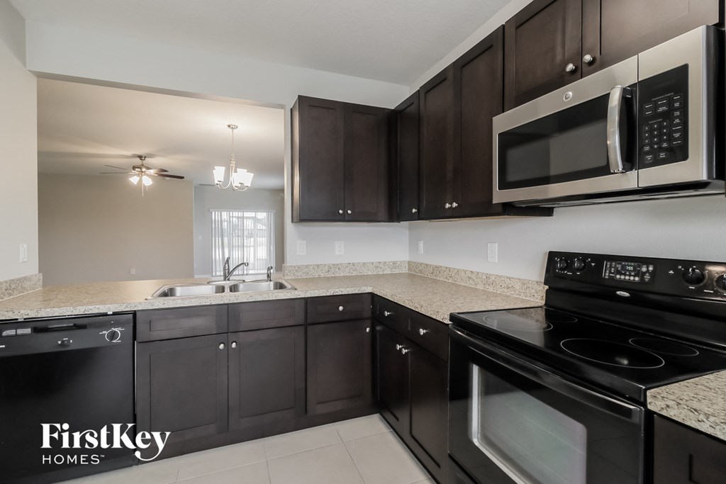 a kitchen with black appliances and granite counter tops