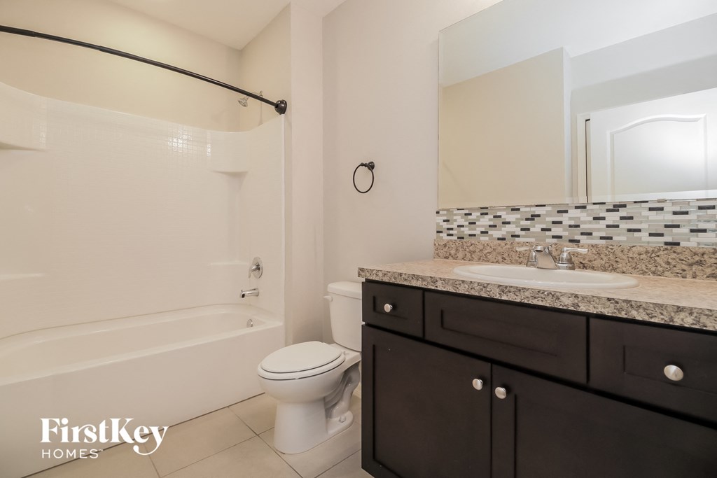 a bathroom with a sink toilet and a bath tub