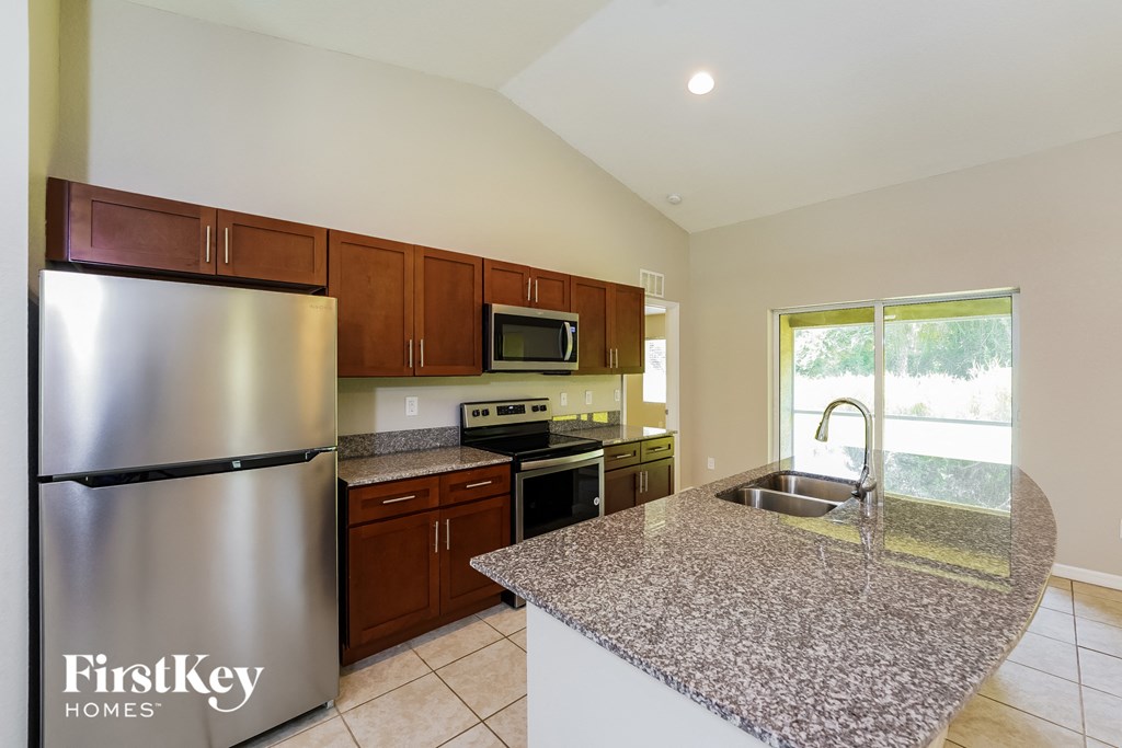 a kitchen with granite counter tops and stainless steel appliances