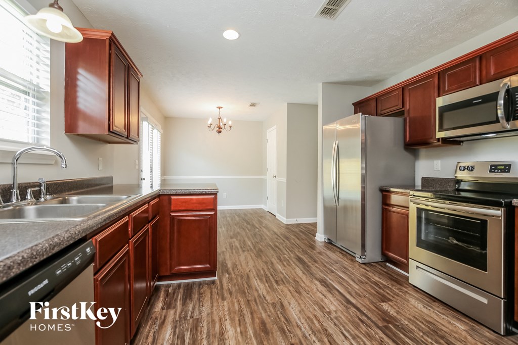 a kitchen with stainless steel appliances and wooden cabinets