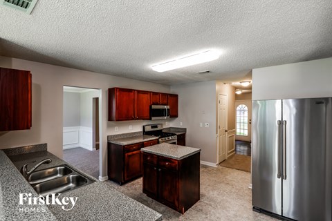 a kitchen with stainless steel appliances and granite counter tops