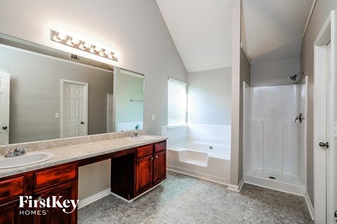 a bathroom with a large mirror and a sink and a bath tub