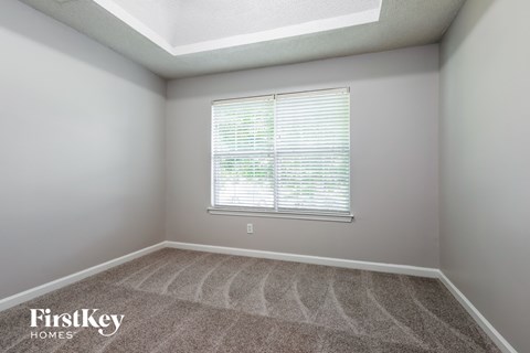 a empty room with a window and carpet