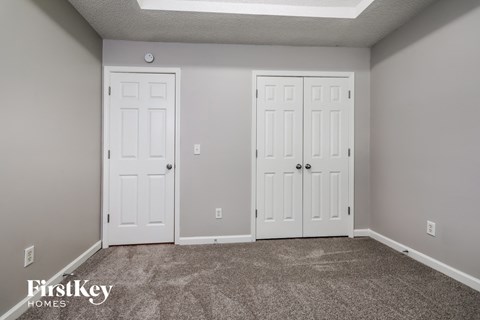 a room with two white doors and a carpeted floor