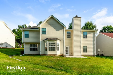 a white house with white siding and a green lawn
