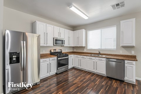 A kitchen with wooden floors and stainless steel appliances.