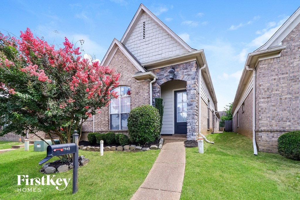 a brick house with a blue mailbox in front of it