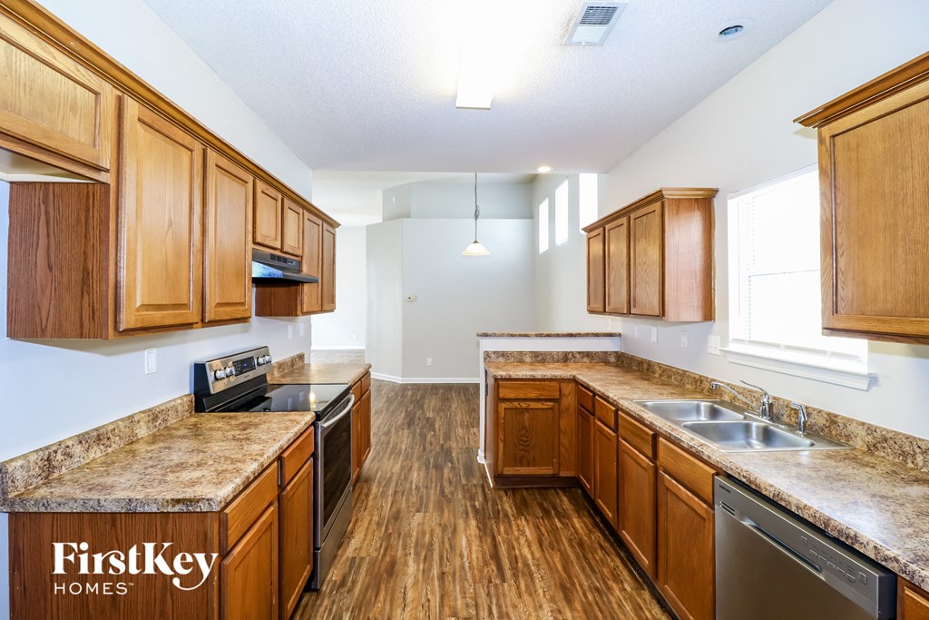 a kitchen with wooden cabinets and stainless steel appliances