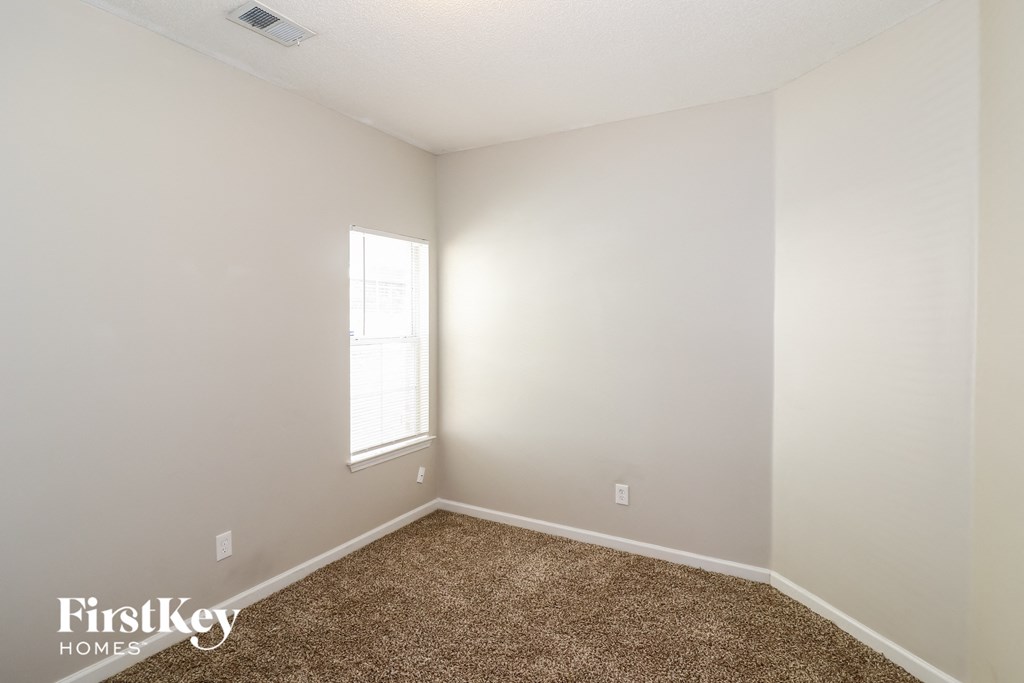a room with a carpet and a window
