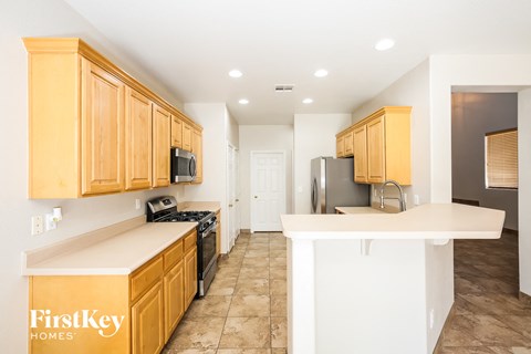 A kitchen with wooden cabinets and a white countertop.