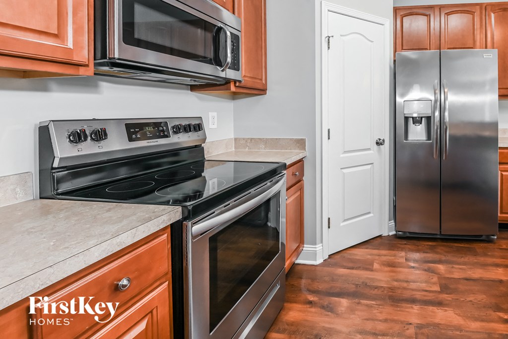 a kitchen with stainless steel appliances and wooden cabinets