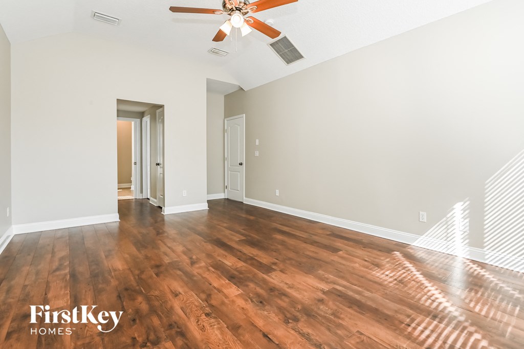 a living room with hardwood floors and a ceiling fan