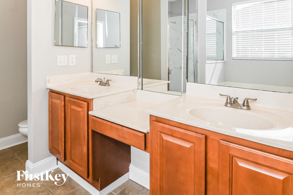 a bathroom with two sinks and a large mirror