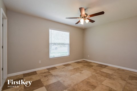 the living room of a home with a ceiling fan