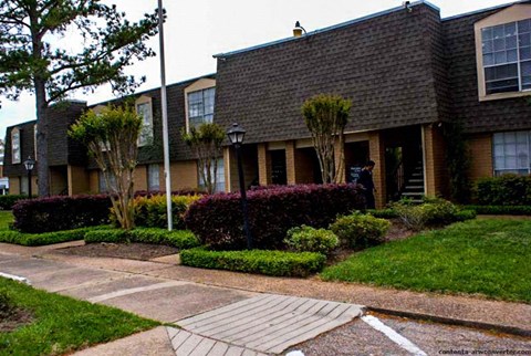 an apartment building with a walkway in front of it