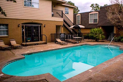a large swimming pool in front of a house