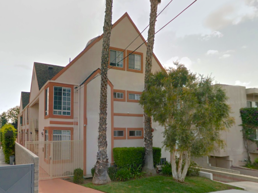 a building with palm trees in front of it