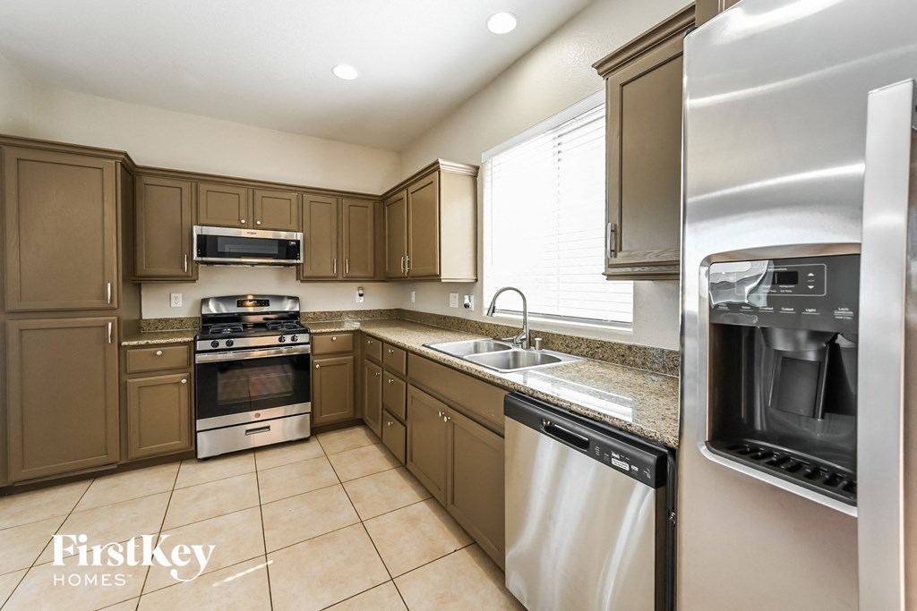 a kitchen with stainless steel appliances and wooden cabinets