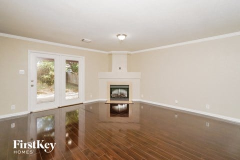 a living room with a fireplace and a wooden floor