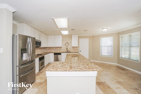 a kitchen with a granite counter top and stainless steel appliances