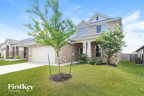 a home with two trees in the front yard