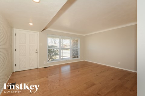 A room with wooden floors and a white door.