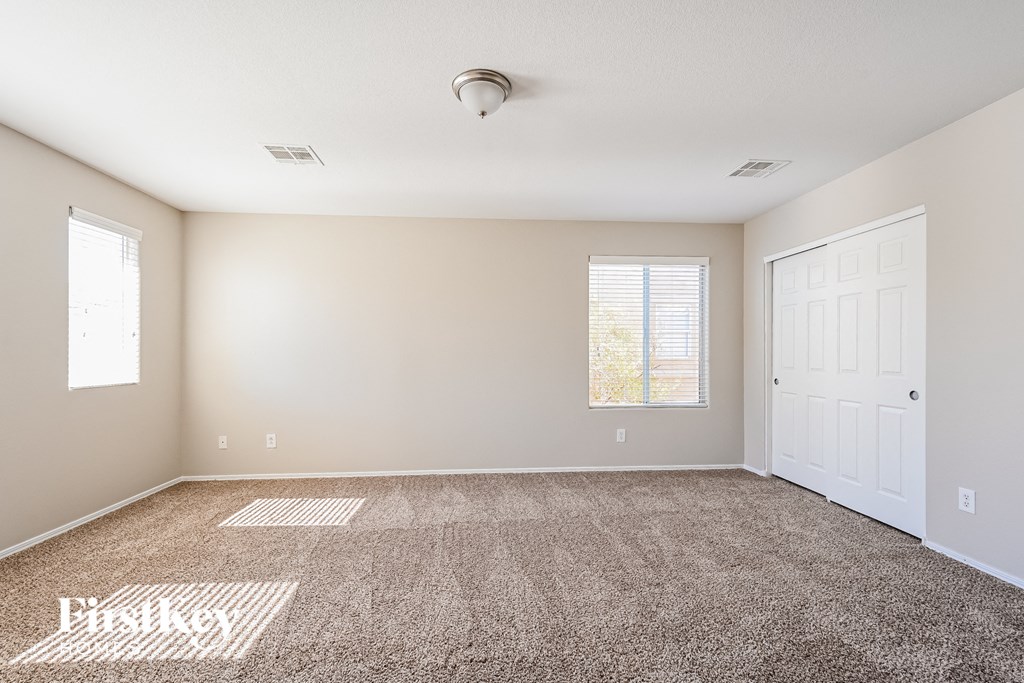 a empty room with carpet and a white door