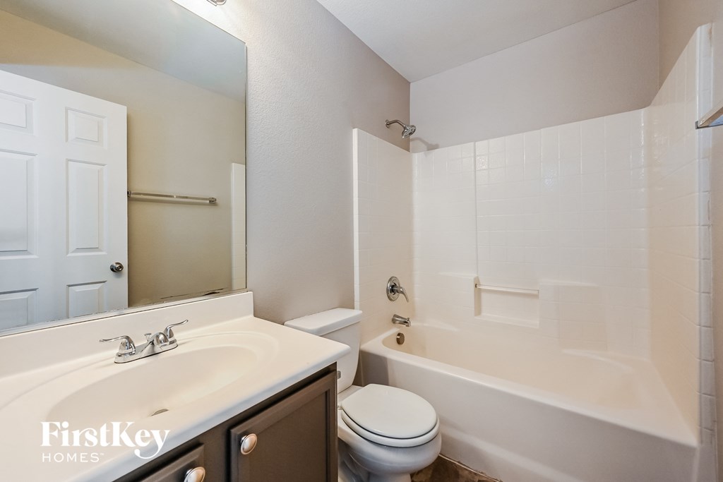 a bathroom with a sink toilet and a tub