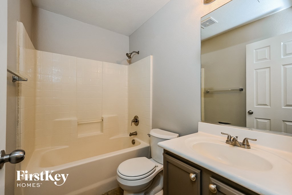 a bathroom with a sink toilet and a tub