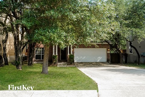 the front of a house with a driveway and a garage door