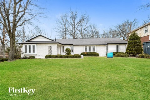 a white house with a yard and a blue mailbox