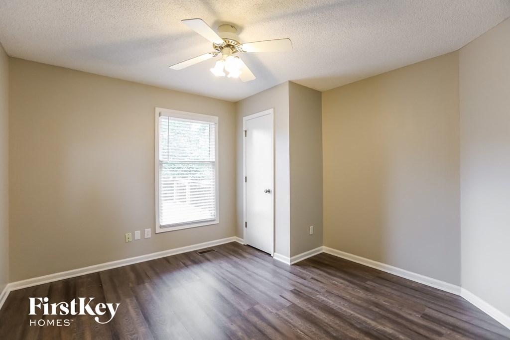 a living room with hardwood floors and a ceiling fan