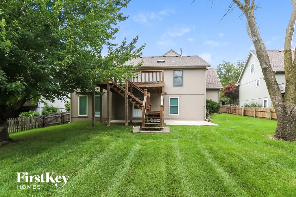 a backyard with a deck and a house