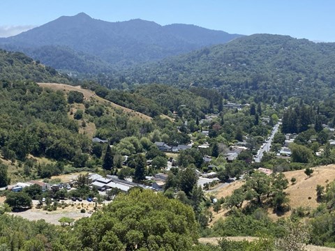 A small town nestled in the valley of a mountain range.
