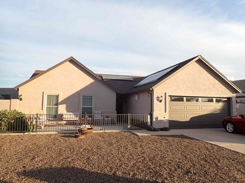 a house with a fence and a car in front of it