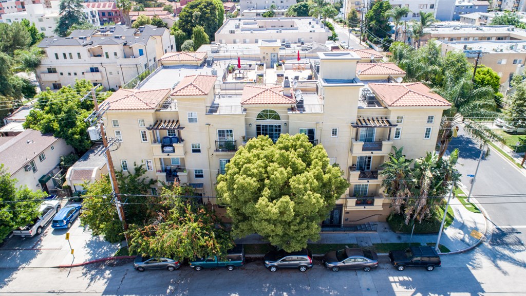 a view of the building from above with cars parked in front of it