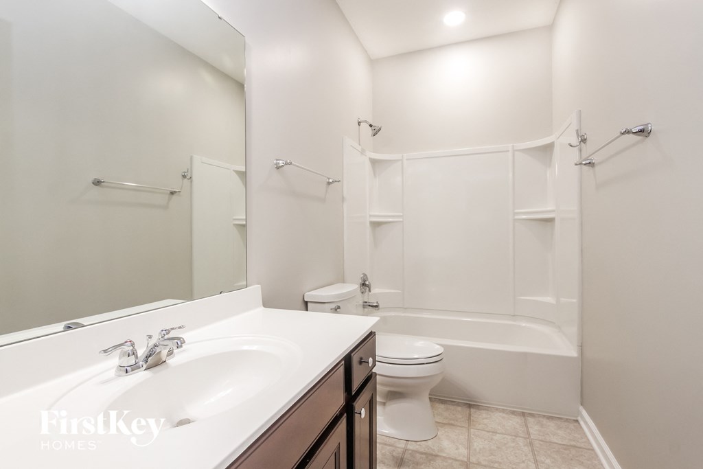 a bathroom with a sink and a toilet and a shower
