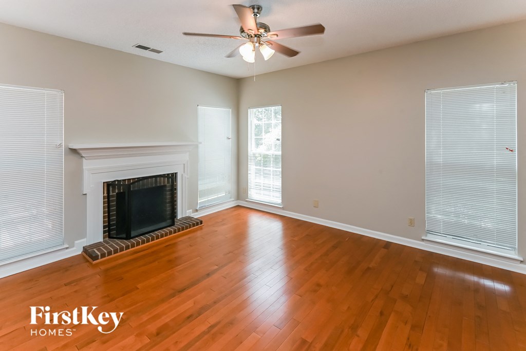 a living room with wood floors and a fireplace