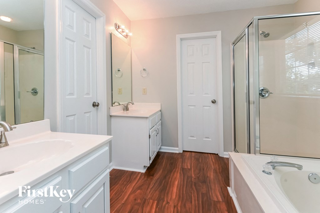 a bathroom with a sink and a shower and a mirror