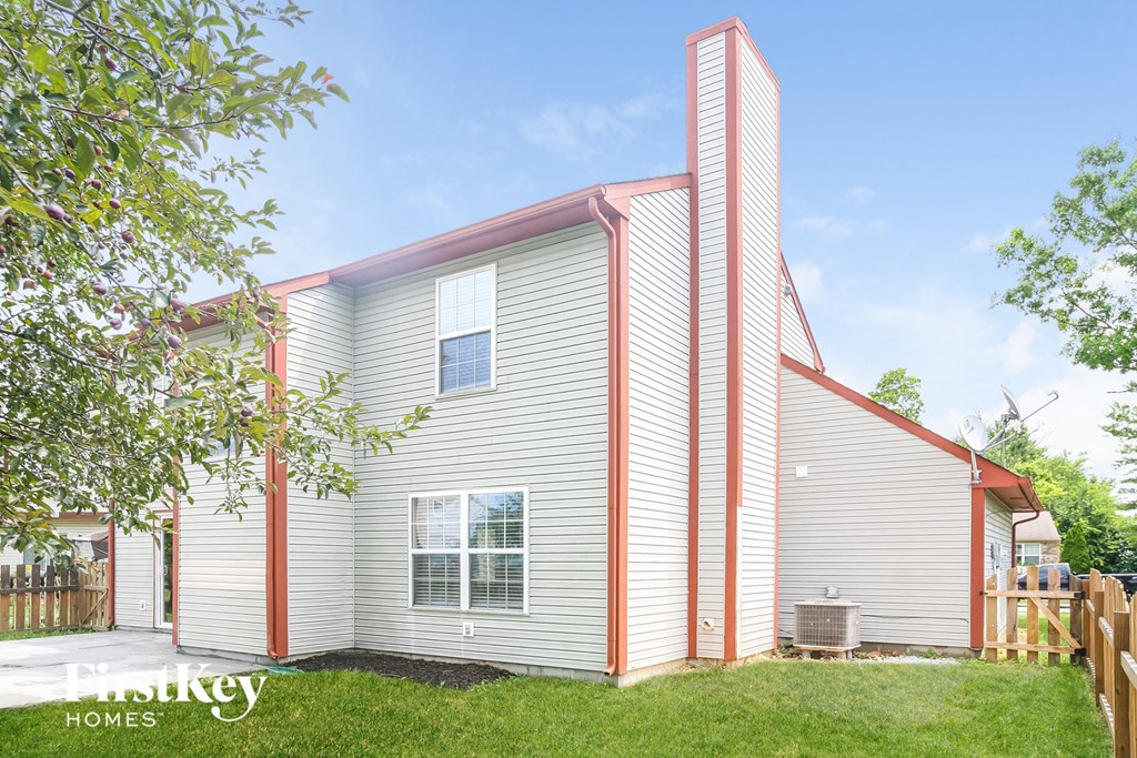 the exterior of a home with a white house and a pink roof