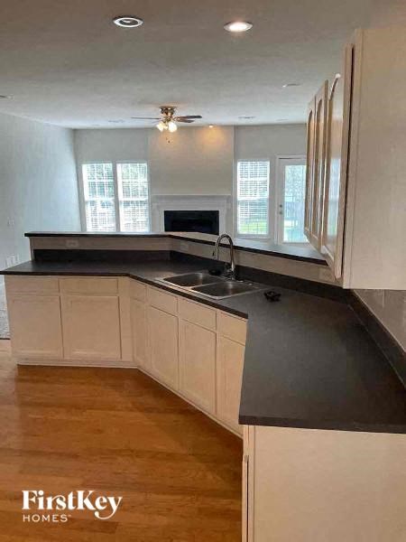 a kitchen with a black counter top and a sink