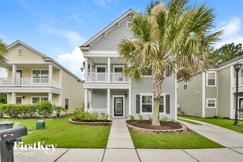 a white house with a palm tree in front of it