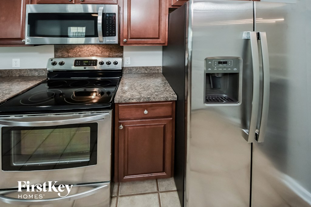 a kitchen with stainless steel appliances and granite counter tops