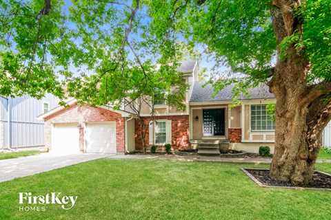 A house with a tree in front of it.
