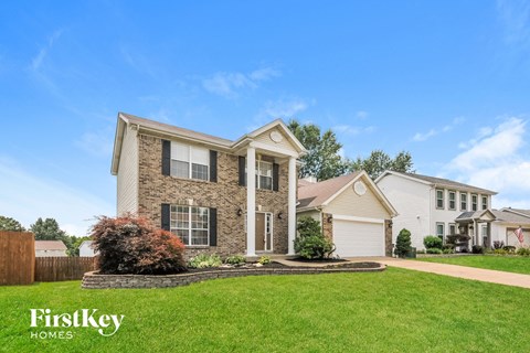 a brick house with a lawn in front of it