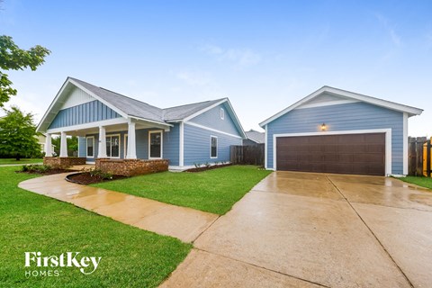 A blue house with a garage is shown in the image.