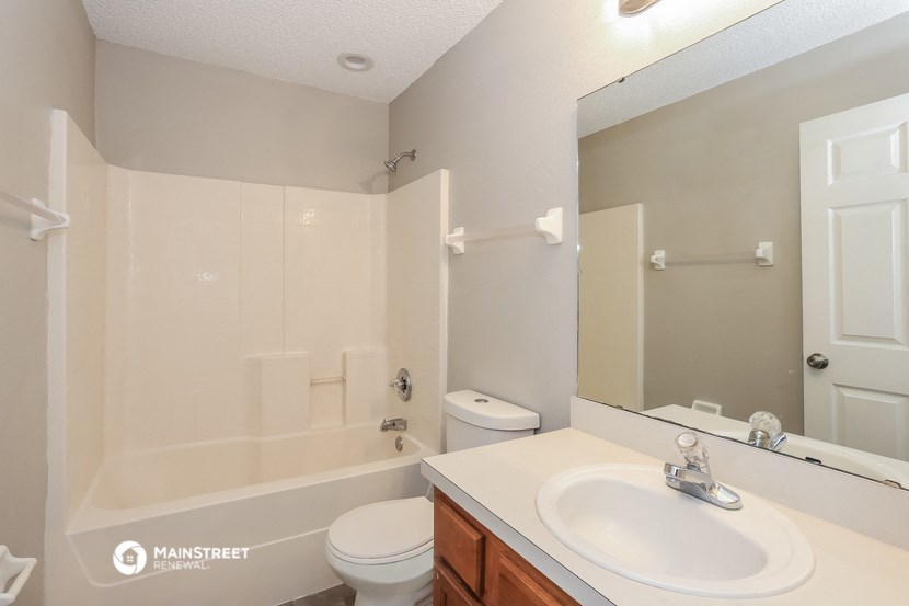 the preserve at ballantyne commons apartment bathroom with tub sink and mirror
