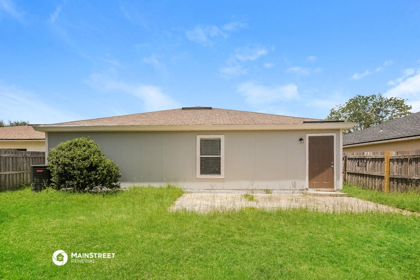 the backyard of a house with a yard and a garage