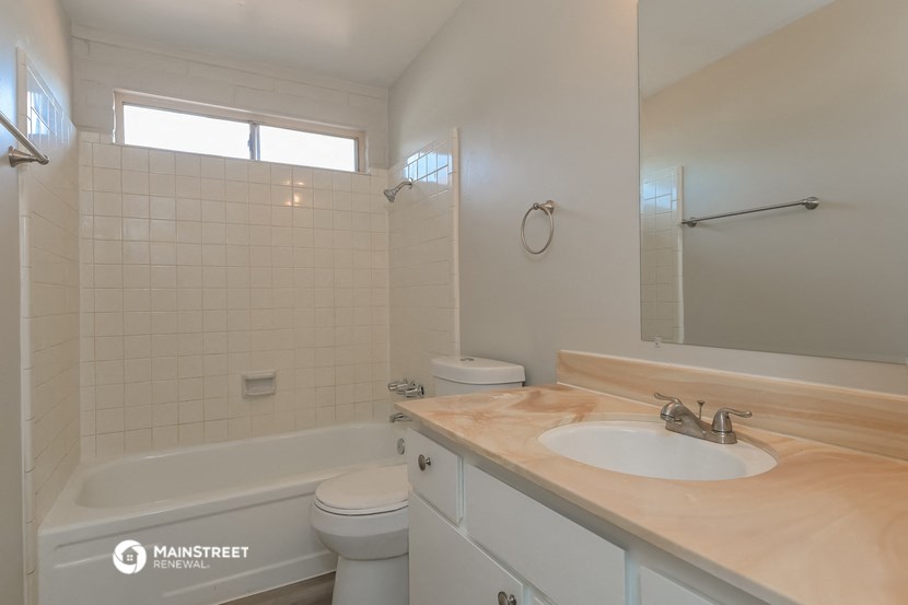 a bathroom with a sink and a toilet and a bath tub